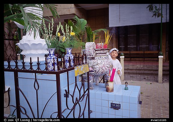 Kid in mourning dress at an outdoor altar, Xa Loi pagoda, district 3. Ho Chi Minh City, Vietnam