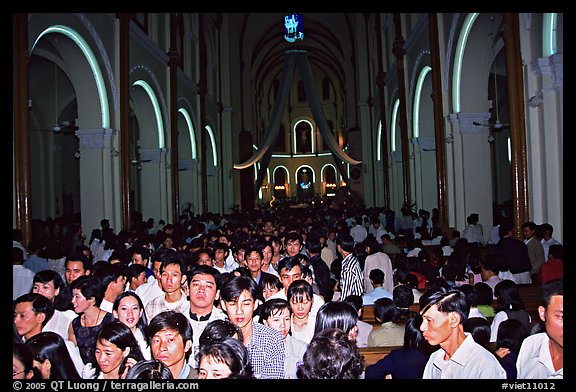 Crowds exit the Cathedral St Joseph at the end of the Christmas mass. Ho Chi Minh City, Vietnam (color)