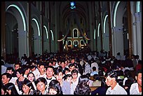 Crowds exit the Cathedral St Joseph at the end of the Christmas mass. Ho Chi Minh City, Vietnam