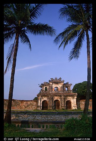 Palm trees and gate, Hue citadel. Hue, Vietnam (color)