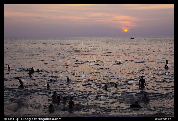 People bathing in Gulf of Thailand waters at sunset. Phu Quoc Island, Vietnam (color)