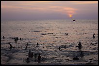 People bathing in Gulf of Thailand waters at sunset. Phu Quoc Island, Vietnam