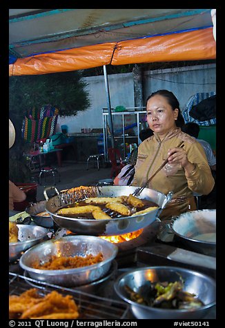 Woman preparing food, Dinh Cau Night Market. Phu Quoc Island, Vietnam (color)
