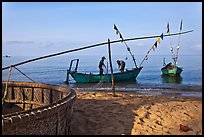 Fishermen pulling net onto skiff. Phu Quoc Island, Vietnam ( color)