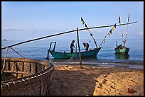 Fishermen pulling net onto skiff. Phu Quoc Island, Vietnam