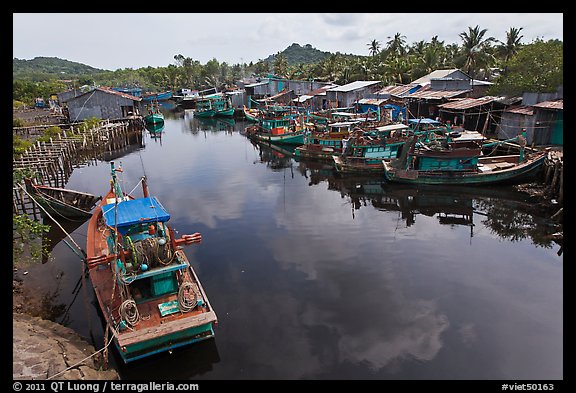 Fishing boats along dark river. Phu Quoc Island, Vietnam