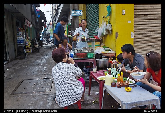 Breakfast at food stall in alley. Ho Chi Minh City, Vietnam (color)