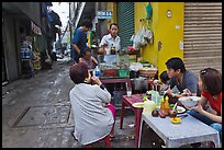 Breakfast at food stall in alley. Ho Chi Minh City, Vietnam