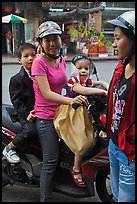 Woman riding with children. Ho Chi Minh City, Vietnam ( color)