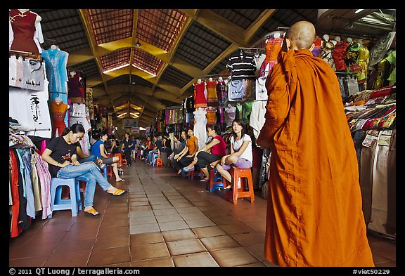 Buddhist Monk walking into Ben Thanh Market. Ho Chi Minh City, Vietnam