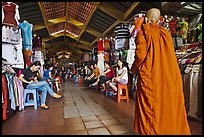 Buddhist Monk walking into Ben Thanh Market. Ho Chi Minh City, Vietnam