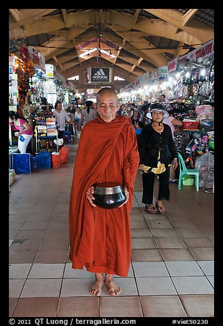 Buddhist Monk doing alms round in Ben Thanh Market. Ho Chi Minh City, Vietnam (color)