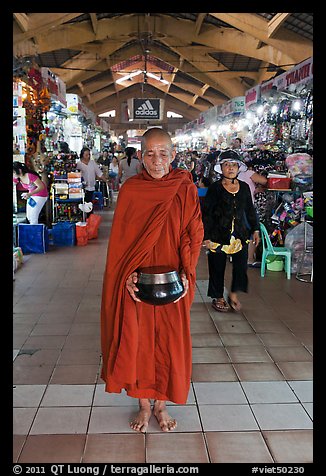 Buddhist Monk doing alms round in Ben Thanh Market. Ho Chi Minh City, Vietnam