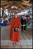 Buddhist Monk doing alms round in Ben Thanh Market. Ho Chi Minh City, Vietnam