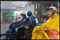 Motorcycle riders during afternoon mooson. Ho Chi Minh City, Vietnam