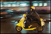 Scooter rider on rainy night. Ho Chi Minh City, Vietnam