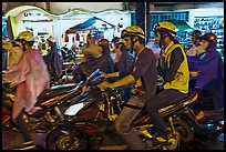 Street crowded with motorcycles on rainy night. Ho Chi Minh City, Vietnam ( color)