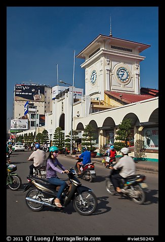 Chaotic motorcycle traffic outside Ben Thanh Market. Ho Chi Minh City, Vietnam (color)
