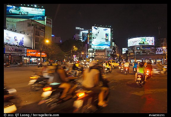 Moving traffic at night on traffic circle. Ho Chi Minh City, Vietnam (color)