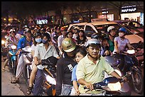 Riders waiting for traffic light at night. Ho Chi Minh City, Vietnam