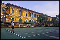 Men play tennis in front of colonial-area courthouse. Ho Chi Minh City, Vietnam ( color)