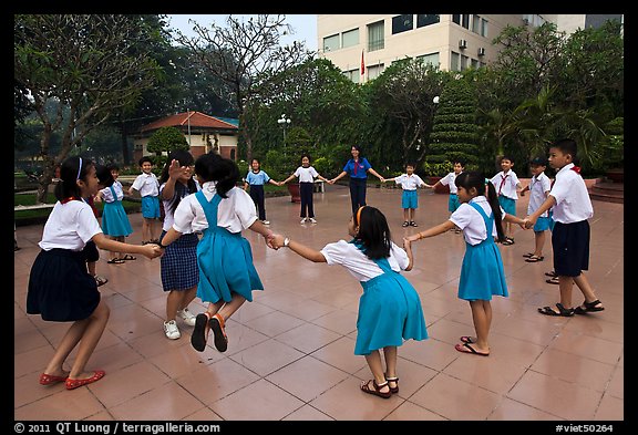 Children playing in circle in park. Ho Chi Minh City, Vietnam