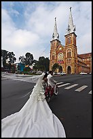 Bride with flowing dress in front of Cathedral. Ho Chi Minh City, Vietnam (color)