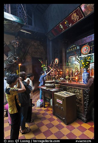 Women at altar, Phuoc Hai Tu temple, district 3. Ho Chi Minh City, Vietnam (color)