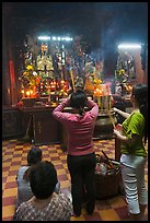 Women offering incense to Jade Emperor figure, Phuoc Hai Tu pagoda, district 3. Ho Chi Minh City, Vietnam