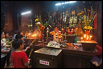 Man lightening candles, Jade Emperor Pagoda, District 3. Ho Chi Minh City, Vietnam ( color)