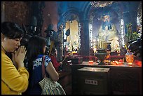 Women worshipping Thang Hoang, Phuoc Hai Tu pagoda, district 3. Ho Chi Minh City, Vietnam (color)