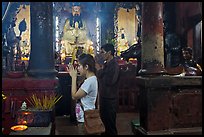 Couple worshipping Thang Hoang, Chua Ngoc Hoang pagoda, district 3. Ho Chi Minh City, Vietnam