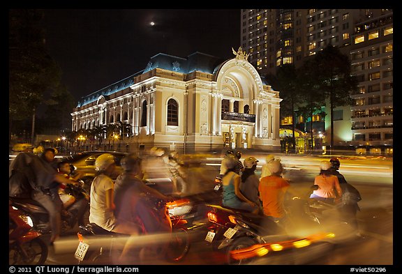 Motorbikes and colonial-area Opera House at night. Ho Chi Minh City, Vietnam (color)