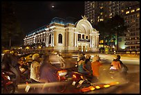 Motorbikes and colonial-area Opera House at night. Ho Chi Minh City, Vietnam (color)