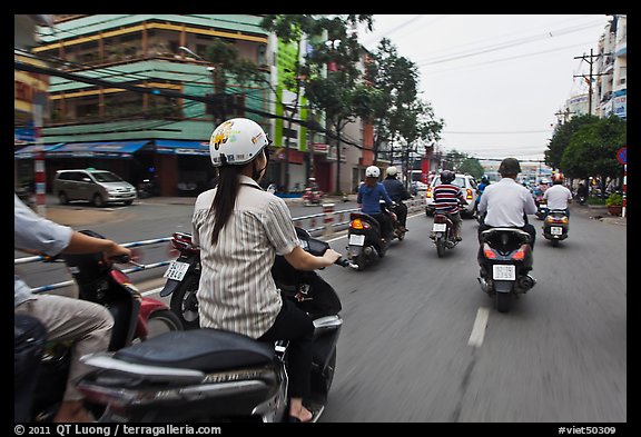 Motorcycle traffic seen from the street. Ho Chi Minh City, Vietnam (color)