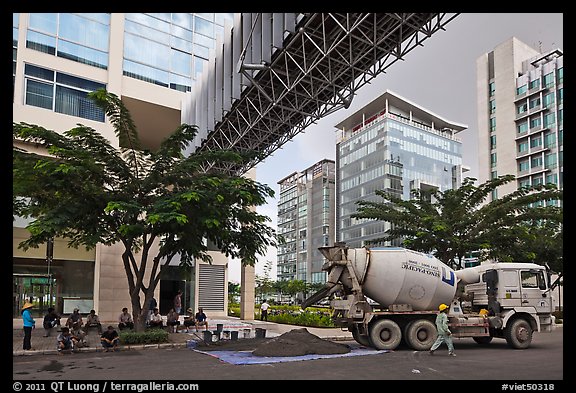 Asphalt truck and new urban area, Phu My Hung, district 7. Ho Chi Minh City, Vietnam (color)