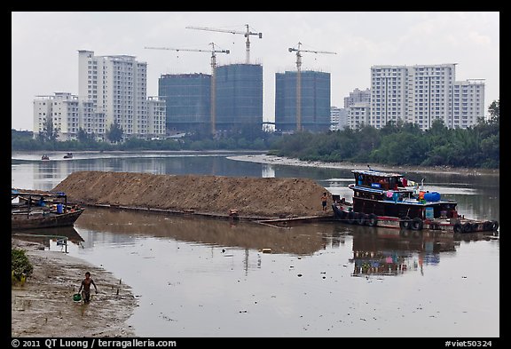 River scene and high rise towers in construction, Phu My Hung, district 7. Ho Chi Minh City, Vietnam (color)