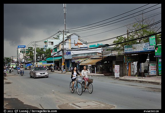 Street with moonson clouds, district 7. Ho Chi Minh City, Vietnam (color)