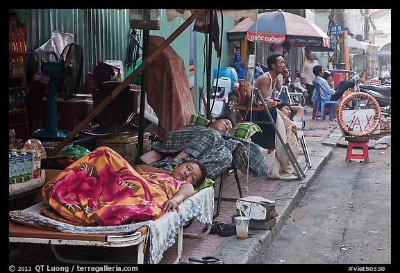 Vendors sleeping on the street at dawn. Ho Chi Minh City, Vietnam (color)