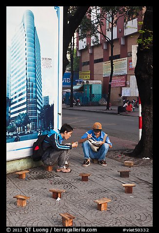 Men having breakfast on a sidewalk. Ho Chi Minh City, Vietnam (color)