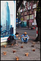 Men having breakfast on a sidewalk. Ho Chi Minh City, Vietnam