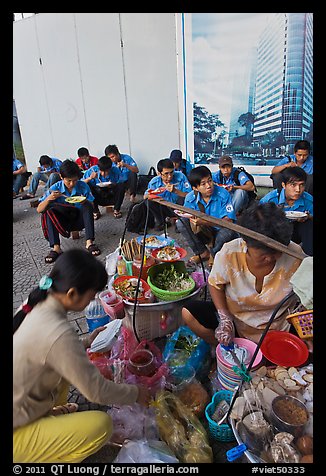 Food vendor preparing breakfast on the street. Ho Chi Minh City, Vietnam (color)