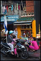 Neighborhood chat in front of street altar. Ho Chi Minh City, Vietnam (color)