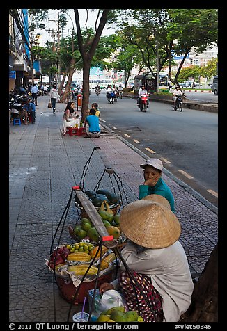 Women selling fruit on a large boulevard. Ho Chi Minh City, Vietnam (color)