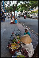 Women selling fruit on a large boulevard. Ho Chi Minh City, Vietnam (color)