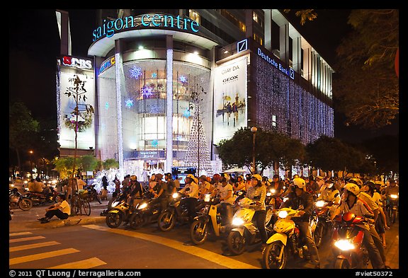 Dense motorcycle traffic in front of Saigon Center at night. Ho Chi Minh City, Vietnam