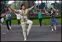 People practicisng Tai Chi with swords, Tao Dan Park. Ho Chi Minh City, Vietnam