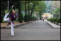 Woman plays badminton using feet (footbag), Tao Dan Park. Ho Chi Minh City, Vietnam