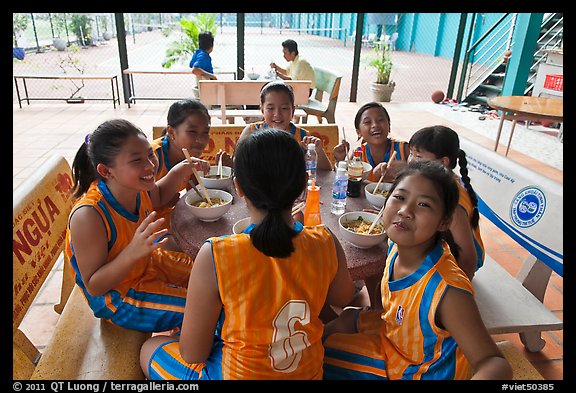 Girls athetics team eating, Cong Vien Van Hoa Park. Ho Chi Minh City, Vietnam (color)