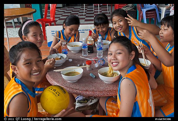 Girls sports team eating, Cong Vien Van Hoa Park. Ho Chi Minh City, Vietnam